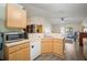 Bright kitchen featuring modern appliances, light wood cabinets and hardwood floors at 24841 Mary Beth Ct, Land O Lakes, FL 34639