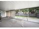 A sunroom with large windows overlooking the backyard at 24841 Mary Beth Ct, Land O Lakes, FL 34639