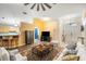 Bright living room with a high ceiling, ceiling fan, hardwood floors and an ornate area rug at 24841 Mary Beth Ct, Land O Lakes, FL 34639