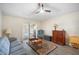 Cozy living room featuring hardwood floors, a ceiling fan, and access to the lanai at 24841 Mary Beth Ct, Land O Lakes, FL 34639