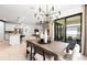Bright dining area featuring a wooden table, stylish chandelier, and seamless access to outdoor patio at 2522 Charter Oak Dr, North Port, FL 34289