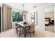 Bright dining room features modern lighting, a wood table, and large windows for natural light and views at 2522 Charter Oak Dr, North Port, FL 34289