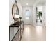 Bright entryway features a console table with decor, tile flooring, and a glimpse into the living spaces at 2522 Charter Oak Dr, North Port, FL 34289