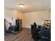 Finished basement area with exercise equipment, computer desk, and mini refrigerator at 2607 N 59Th St, Tampa, FL 33619