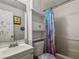 Cozy bathroom featuring a vanity, built-in shelves above the toilet, and a shower with a curtain at 2607 N 59Th St, Tampa, FL 33619