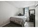 Neutral bedroom featuring wood-look flooring, a comfy bed, and a classic dark dresser at 2607 N 59Th St, Tampa, FL 33619