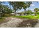 Exterior view of the home featuring a fenced yard, mature trees, and a well-maintained lawn at 2607 N 59Th St, Tampa, FL 33619