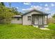 Cozy single-story house featuring a screened-in porch, a well-maintained lawn, and classic architectural details at 2607 N 59Th St, Tampa, FL 33619