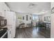 Open kitchen and dining area with modern appliances, white cabinetry, and a seamless transition for entertaining and daily living at 2607 N 59Th St, Tampa, FL 33619