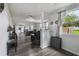 Open-concept living area featuring modern flooring, neutral colors, and abundant natural light from large windows at 2607 N 59Th St, Tampa, FL 33619