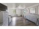Bright main bedroom featuring wood-look floors, white walls, and stylish modern furnishings at 2607 N 59Th St, Tampa, FL 33619