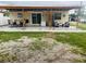 Backyard with a covered patio area, grass, and gravel, perfect for entertaining at 2610 W Powhatan Ave, Tampa, FL 33614