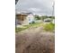 View of a large backyard with gravel, grass, and a covered patio area at 2610 W Powhatan Ave, Tampa, FL 33614