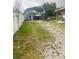 Wide backyard featuring a car port and a white vinyl fence for privacy at 2610 W Powhatan Ave, Tampa, FL 33614