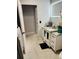 Bathroom featuring tiled floor, vanity with white cabinets, and modern fixtures at 2610 W Powhatan Ave, Tampa, FL 33614