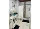 Bathroom featuring tiled shower, vanity with white cabinets, and modern fixtures at 2610 W Powhatan Ave, Tampa, FL 33614