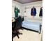 Cozy bedroom featuring personal decorations, a bed, and a study space at 2610 W Powhatan Ave, Tampa, FL 33614