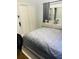 Bedroom featuring a bed, closet, and dresser with a mirror at 2610 W Powhatan Ave, Tampa, FL 33614