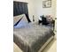 Bedroom featuring a bed, nightstand, desk and chair at 2610 W Powhatan Ave, Tampa, FL 33614