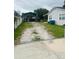 Long gravel driveway leading to a covered parking area, offering ample space at 2610 W Powhatan Ave, Tampa, FL 33614