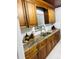 Well-lit kitchen featuring wood cabinets, granite countertops, and modern fixtures at 2610 W Powhatan Ave, Tampa, FL 33614