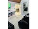 Modern living room with sleek tile flooring, a decorative fireplace, and comfortable seating at 2610 W Powhatan Ave, Tampa, FL 33614