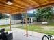 View from a covered patio looking out into a spacious backyard with mature trees at 2610 W Powhatan Ave, Tampa, FL 33614