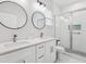 Modern bathroom with double sinks, frameless glass shower, and stylish fixtures at 2809 N 21St St, Tampa, FL 33605