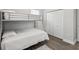 Cozy bedroom featuring a bunk bed, closet, and wood-look flooring creating a comfortable living space at 2809 N 21St St, Tampa, FL 33605