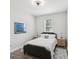 Comfortable bedroom featuring a neutral color palette, hardwood floors, and a window with blinds at 2809 N 21St St, Tampa, FL 33605