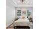 Bright bedroom with tray ceiling, painting, and natural light from large windows at 2809 N 21St St, Tampa, FL 33605