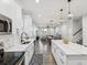 Open concept kitchen showcasing white cabinets, stainless steel appliances, and hardwood floors at 2809 N 21St St, Tampa, FL 33605