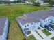 Aerial view showcases the roof, driveway, and landscaping of a townhome at 3062 Victoria Inlet Dr, Holiday, FL 34691