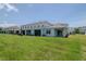 Spacious backyard view of this townhome featuring a covered patio, and ample green space at 3062 Victoria Inlet Dr, Holiday, FL 34691