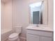 Well-lit bathroom with a toilet, tub, and vanity with a mirror at 3062 Victoria Inlet Dr, Holiday, FL 34691