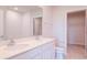 Bathroom with double sinks, white cabinets, large mirror, and a tiled floor at 3062 Victoria Inlet Dr, Holiday, FL 34691