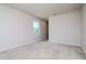 Bright, carpeted bedroom with neutral walls, offering a view of the outdoors through the window at 3062 Victoria Inlet Dr, Holiday, FL 34691