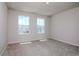 Bright bedroom featuring two windows for natural light and neutral carpeting at 3062 Victoria Inlet Dr, Holiday, FL 34691