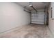 View of a garage with an electric garage door opener and a cement floor at 3062 Victoria Inlet Dr, Holiday, FL 34691