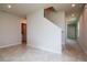 Hallway featuring tiled floors, stairs, and neutral paint tones, offering a welcoming entrance at 3062 Victoria Inlet Dr, Holiday, FL 34691