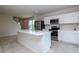 Modern kitchen design includes stainless steel appliances, white cabinets, and central island with breakfast bar and sink at 3062 Victoria Inlet Dr, Holiday, FL 34691