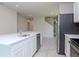Kitchen island with sink, stainless steel dishwasher, and sleek countertops at 3062 Victoria Inlet Dr, Holiday, FL 34691
