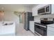 Bright kitchen with stainless steel appliances, white cabinets, and ample counter space at 3062 Victoria Inlet Dr, Holiday, FL 34691