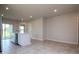 Open kitchen with a central island, tiled floors, recessed lighting and modern finishes provide a clean look at 3062 Victoria Inlet Dr, Holiday, FL 34691