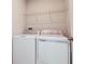 Laundry room featuring a white washer, dryer, and a wire rack for storage at 3062 Victoria Inlet Dr, Holiday, FL 34691