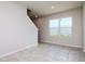 Bright living area with tiled floor and staircase features a large window that provides lots of natural light at 3062 Victoria Inlet Dr, Holiday, FL 34691