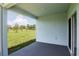 Covered patio showcasing views of the green landscape and blue skies beyond at 3062 Victoria Inlet Dr, Holiday, FL 34691