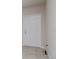 A corner of a room with a white door and tiled floors at 3062 Victoria Inlet Dr, Holiday, FL 34691