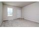 Neutral carpeted room featuring a window and a door to the outside at 3062 Victoria Inlet Dr, Holiday, FL 34691