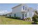 Side view of home showing well-maintained lawn and manicured shrubs lining the side of the home at 3062 Victoria Inlet Dr, Holiday, FL 34691